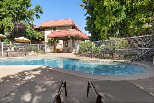 a swimming pool in front of a house at Big Island Kona Mansions 110C by Coldwell Banker Island Vacations in Kailua-Kona