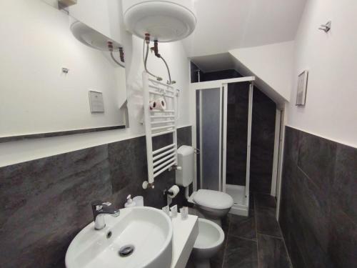 a bathroom with a sink and a toilet at Fiore di Loto Rooms in Carini