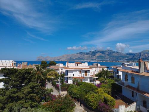 a city with buildings and the ocean in the background at Fiore di Loto Rooms in Carini