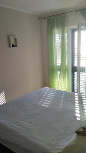 a bedroom with a large bed and a window at More in Vodice