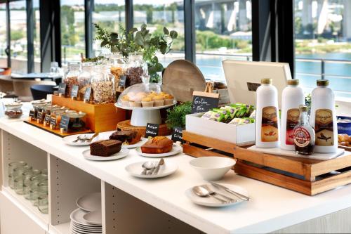 a bakery with a buffet of food on a counter at Golden Tulip Hotel & Rooftop Martigues Provence in Martigues