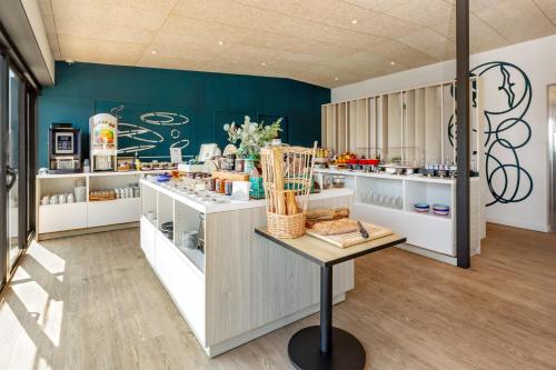 a kitchen with a counter with food on it at Golden Tulip Hotel & Rooftop Martigues Provence in Martigues