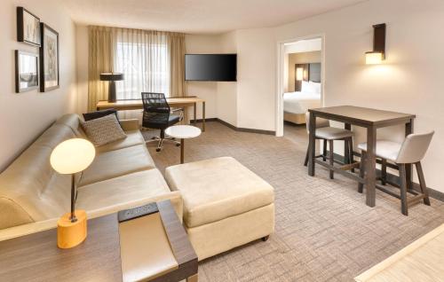 a living room with a couch and a table at Residence Inn by Marriott Whitby in Whitby