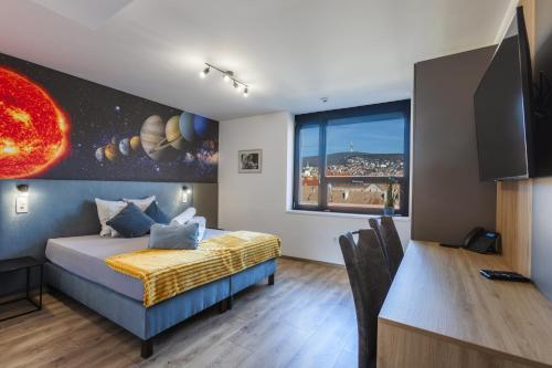 a bedroom with a bed and a desk and a window at R73 Residences in Pécs