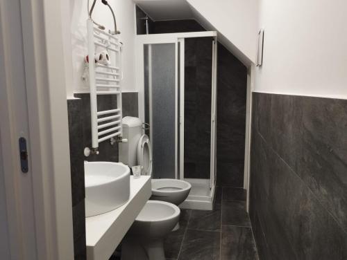 a bathroom with two toilets and a shower at Fiore di Loto Rooms in Carini