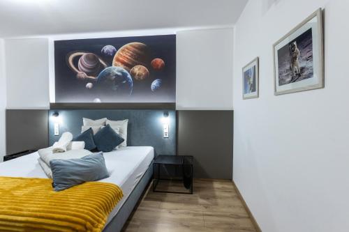 a bedroom with a bed with a yellow blanket at R73 Residences in Pécs
