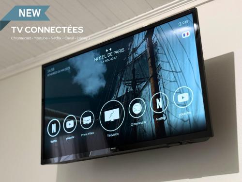 a flat screen tv hanging on a wall at Hotel de Paris in La Rochelle