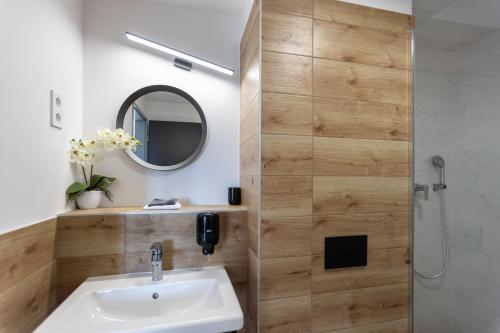 a bathroom with a sink and a shower at R73 Residences in Pécs