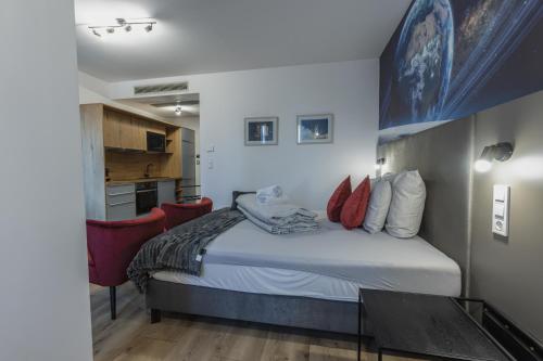 a small bedroom with a bed and a kitchen at R73 Residences in Pécs