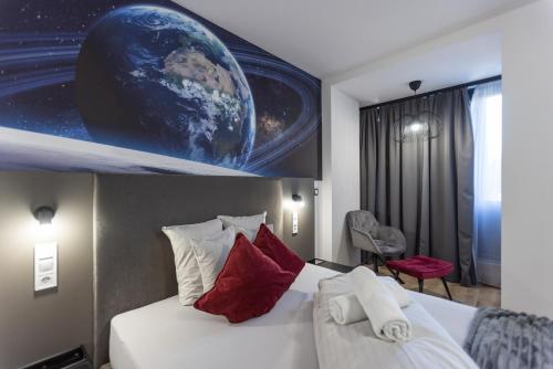 a hotel room with a bed and a planet mural at R73 Residences in Pécs