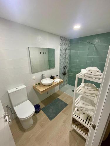 a bathroom with a toilet and a sink and a mirror at La Mata relax in La Mata