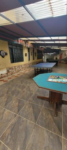 a room with two ping pong tables in it at Finca San Jerónimo in Arbeláez