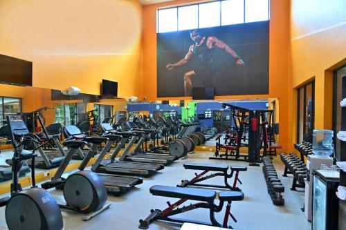 a gym with a bunch of treadles and a large screen at Holiday Inn - Bulawayo by IHG in Bulawayo