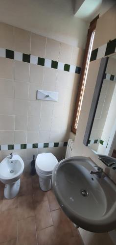 a bathroom with a sink and a toilet at BnBg - Previtali in Bergamo