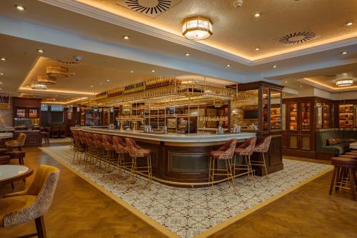 a bar in a restaurant with chairs and tables at The Mercantile Hotel in Dublin