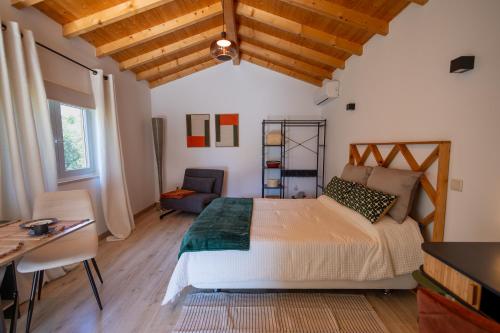 a bedroom with a bed and a table and a desk at Magnolias Cottage in Lousã