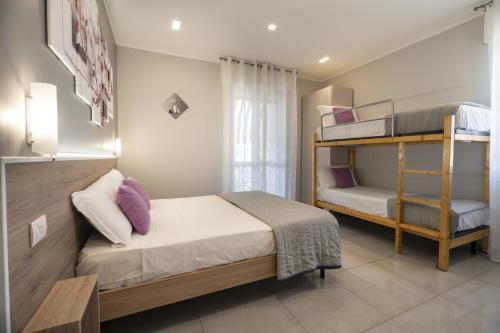 A bed or beds in a room at Affittacamere Orchidea for Tourists Hesperia Hosp