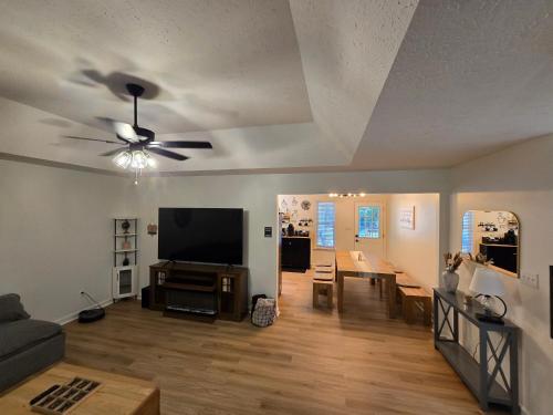 a living room with a ceiling fan and a flat screen tv at Stylish 3bd 2bath home in North Augusta