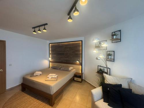 a bedroom with a bed and a window and a couch at STUDIO 46 South Pearl Homes in Sozopol