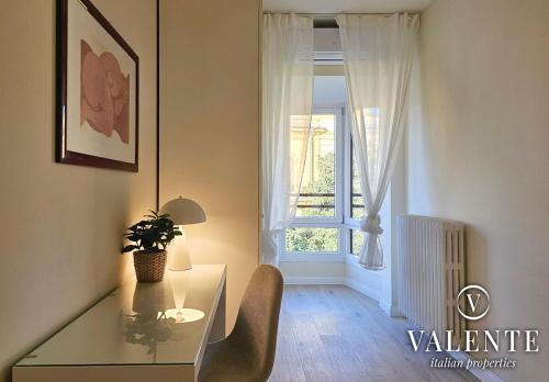 a dining room with a glass table and a window at Central panoramic apartment in Montecatini Terme