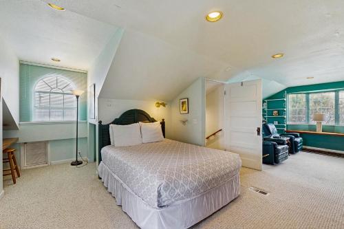 a bedroom with a bed and a room with a window at Far View in Lincoln City