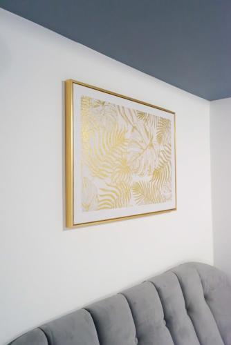 a picture hanging on a wall above a couch at Carlisle Aglionby Escape in Carlisle