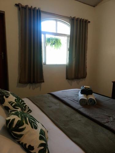 a bed with a stuffed animal sitting on top of it at Jungla Hostel in Alto Paraíso de Goiás