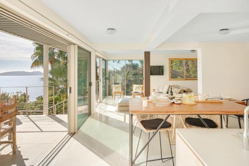 a dining room with a view of the ocean at La Vigie Mont des oiseaux Vue mer panoramique By HC in Hyères