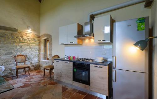 a kitchen with a refrigerator and a stove top oven at Nice Home In Frontino With Wifi in Frontino