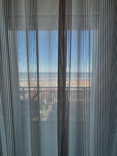 a view of the ocean through the blinds of a window at Abahotel in Milano Marittima