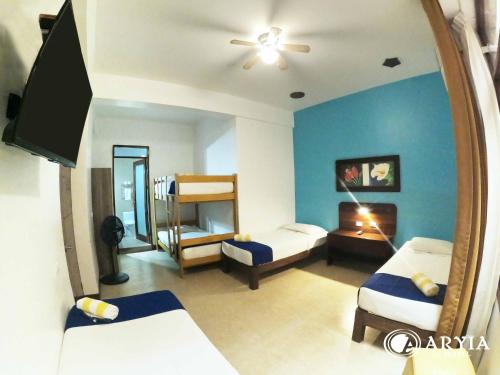 a room with two beds and a mirror at Aryia Máncora in Máncora
