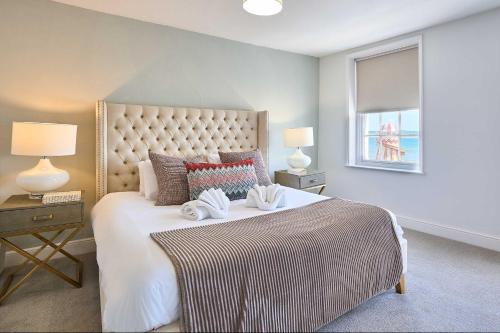 a bedroom with a large bed with two towels on it at Host & Stay - Albert House in Weymouth