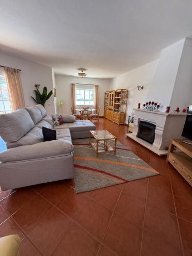 a living room with a couch and a fireplace at Villa Barros by GalanteVasques in Carvoeiro