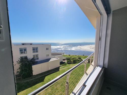 a balcony with a view of the beach at Lagoon Shoreline 2 Bedroom Apartment in Cape Town
