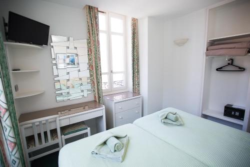 una camera con due letti e una finestra di Hotel Terminus a Saint-Gervais-les-Bains