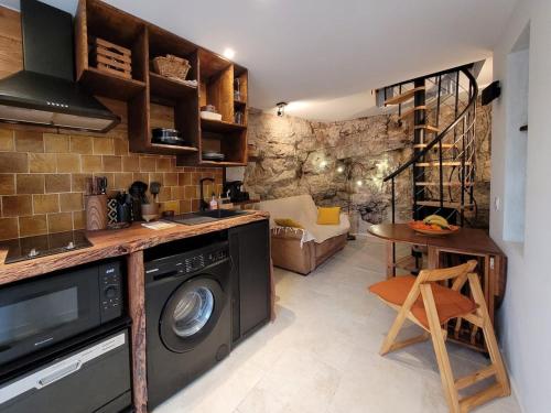 une cuisine avec une machine à laver dans une pièce dans l'établissement Appartement Sillans la cascade village historique, à Sillans-la-Cascade
