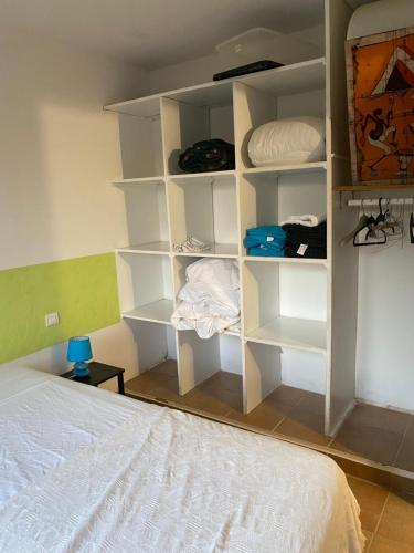 a bedroom with white shelves and a bed at GRANDE VILLA TIZZANO A 200 M DE LA PLAGE 18 PERS in Sartène