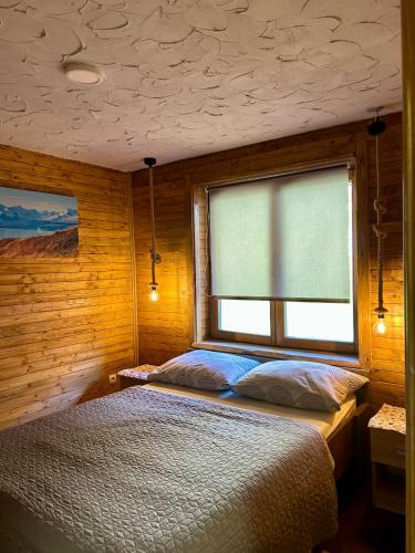a bedroom with a bed and a window at Stara hiža pod Okićem in Jastrebarsko