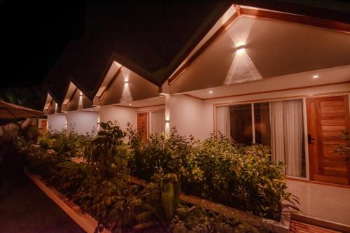 a row of houses lit up at night at Handhuvaru Maldives in Milandu