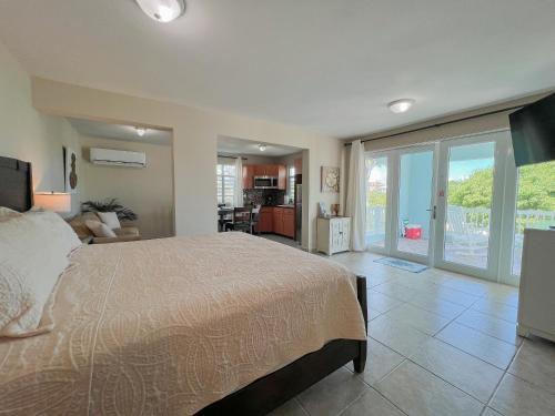 a bedroom with a large bed and a living room at Island Charm Culebra - Studios & Suites - Amazing Water views in Culebra Puerto Rico! in Culebra