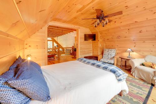 a bedroom with a bed in a log cabin at Hot Tub and Dock Waterfront Cabin in Old Forge! in Old Forge