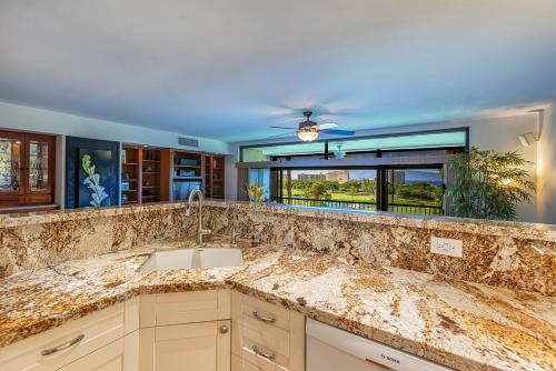 a kitchen with a sink and a counter top at Kaanapali Royal N202 by Coldwell Banker Island Vacations in Lahaina