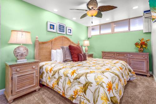 a bedroom with a bed and a ceiling fan at Kahana Reef 305 by Coldwell Banker Island Vacations in Kahana