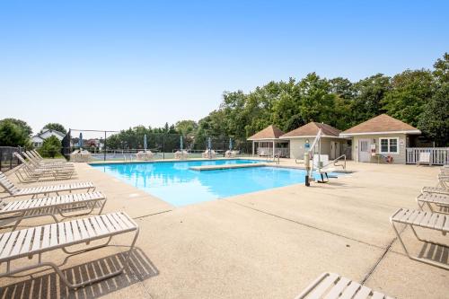 a swimming pool with lounge chairs in a resort at Savannahs Landing --- 10 Mary Elizabeth Dr in Ocean View