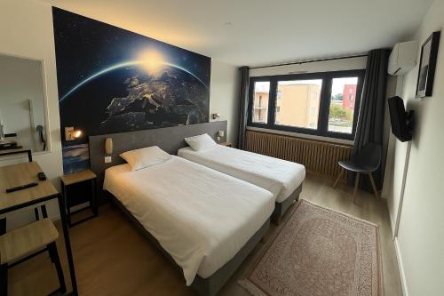 a bedroom with two beds and a large window at Savoie Hotel aux portes de Genève in Saint-Julien-en-Genevois