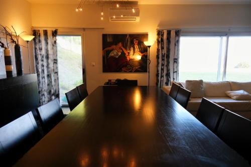 a dining room with a table and a couch at Escusa in Baião