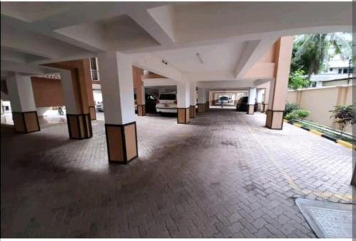 an empty hallway of a building with a car parked at Nyali Fully Furnished Rooms With Swimming pool in Mombasa
