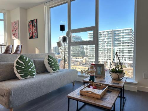a living room with a couch and a table at UBC Pacific Spirit Modern Style Home in Vancouver