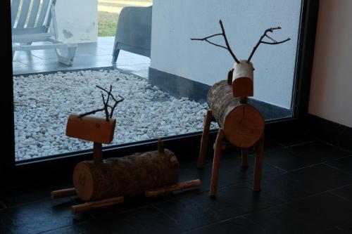 two wooden toy animals sitting in front of a window at Escusa in Baião