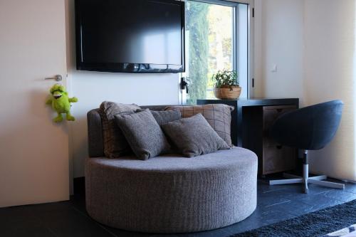 a living room with a couch and a flat screen tv at Escusa in Baião